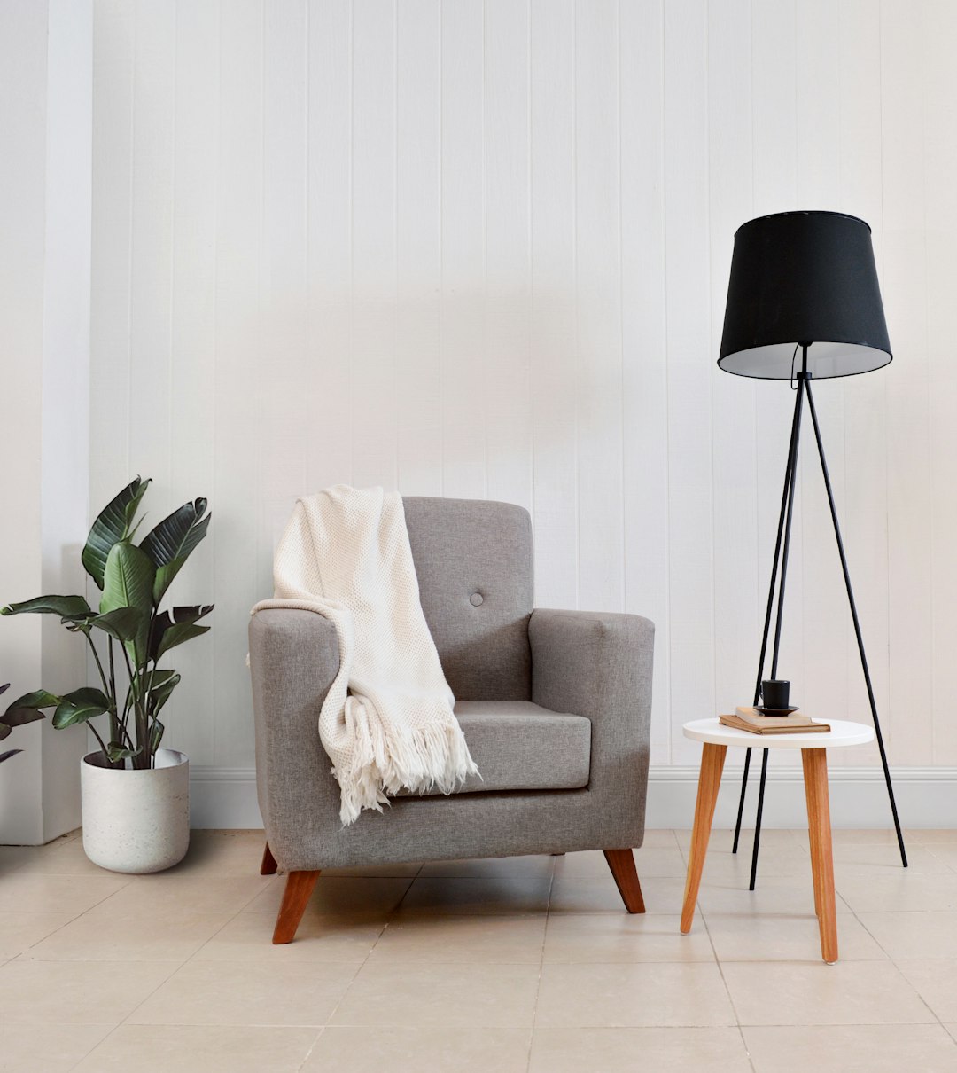 gray-armchair-with-throw-blanket-and-floor-lamp-po6n1rm-pby
